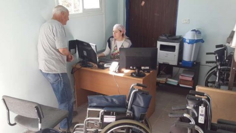 Leah Palmer assists a client with an equipment loan in Yeruham, a town in the Southern periphery.